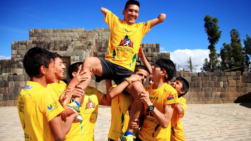 a Para athlete held on the shoulders of other athletes