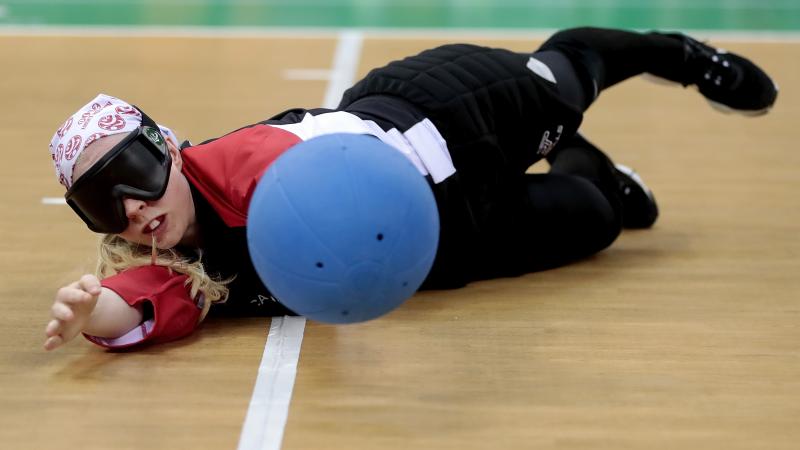 a female goalball player saves a shot