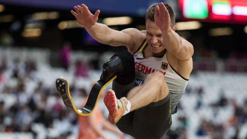 a male Para athlete mid long jump