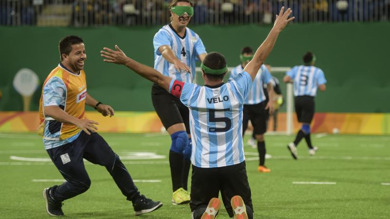 a blind footballer celebrates on his knees