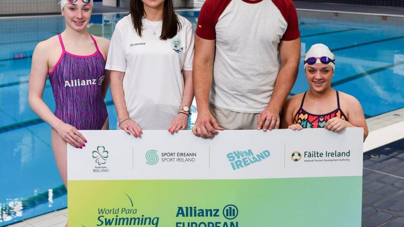 Four people standing showing a big ticket for the Dublin 2018 Para Swimming Euros