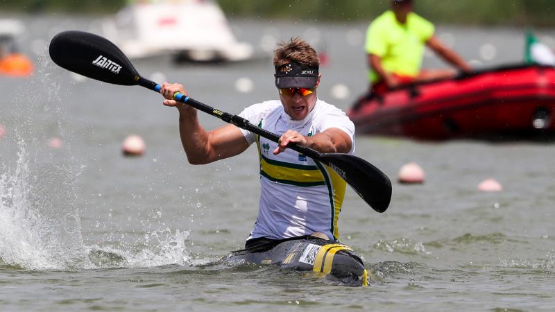 a male Para canoeist mid-stroke