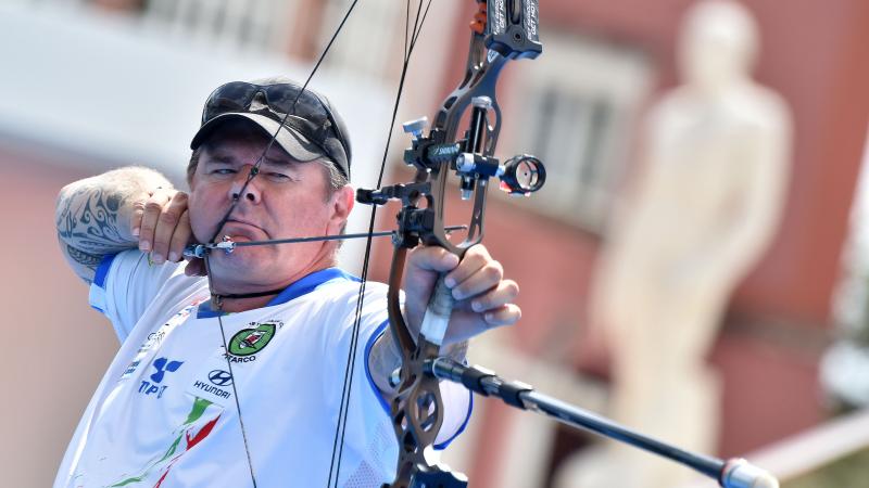 a male Para archer prepares to shoot an arrow