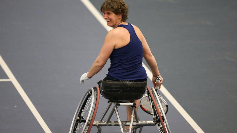 a female wheelchair tennis player on the court