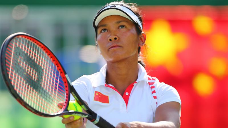 China's Zhenzhen Zhu lines up a serve.