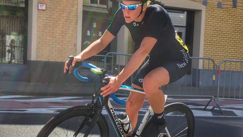 a female Para cyclist comes round a road bend