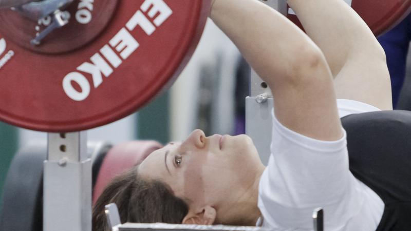 a female powerlifter prepares to lift