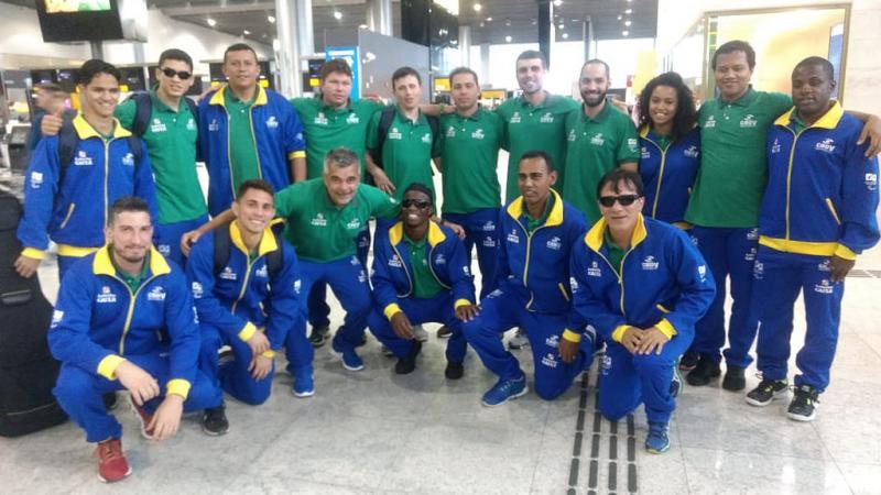 A group of blind footballers smiling in an airport