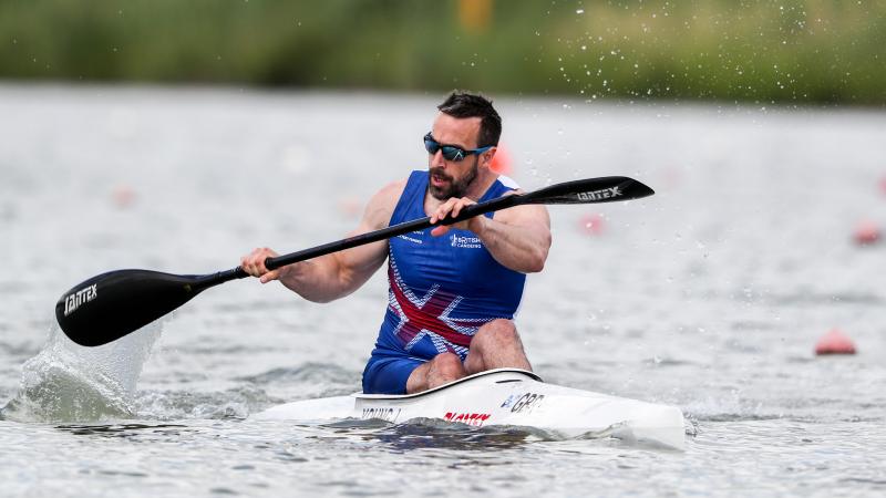 a male canoeist paddles on the water