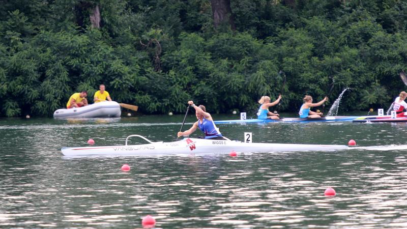 a female Para canoeist mid-stroke on the water