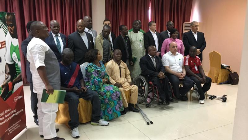 a group of men and women sitting and standing