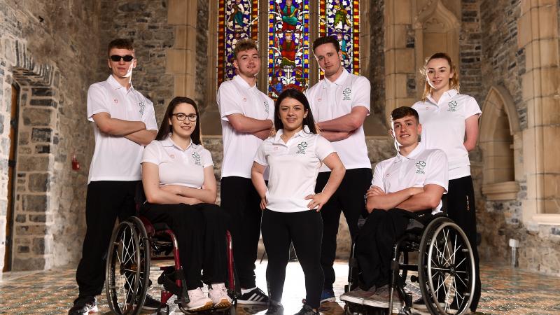 a group of Para athletes sitting and standing