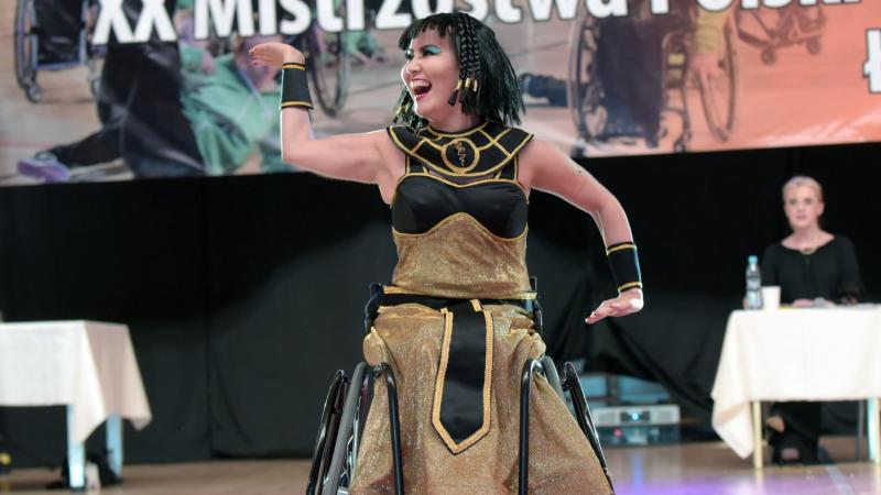 a female Para dance sport athlete strikes a pose dressed as Cleopatra