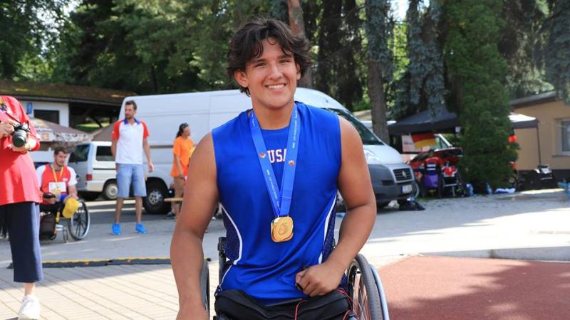 a male wheelchair athlete smiles for the camera