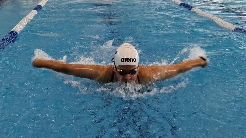 a female Para swimmer mid-stroke