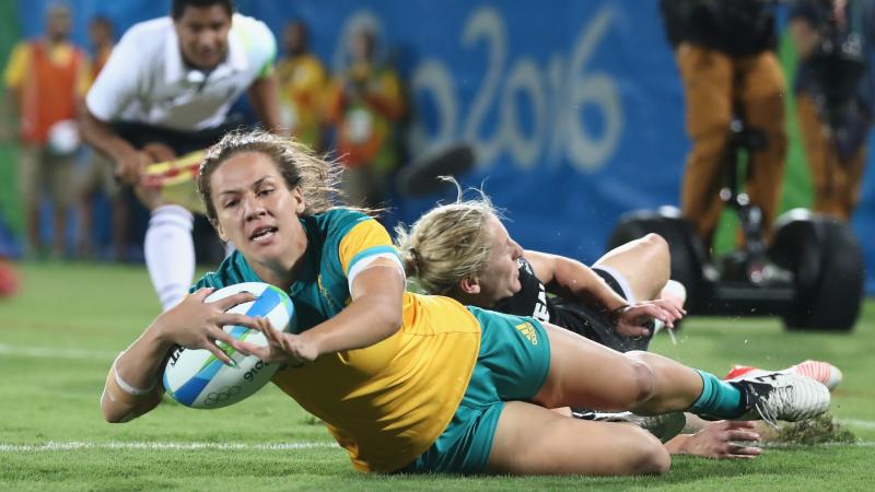 a female rugby player scores a try