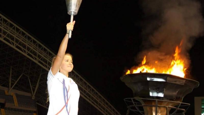 a female Para athlete lighting a cauldron