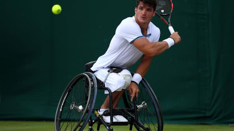 Argentinian male wheelchair tennis player hits a  a backhand shot