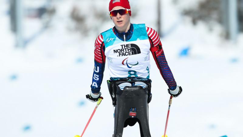 US female Nordic skier pushes on the snowy course