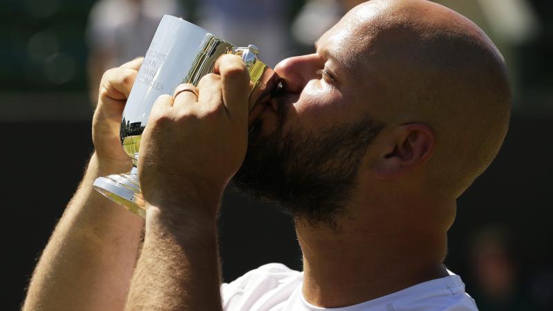 Stefan Olsson - Sweden - Wimbledon 2018 Men holding and kissing a small trophy
