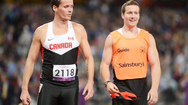 Vision impaired sprinter alongside his guide runner