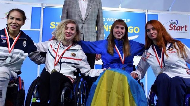 four female wheelchair fencers on the podium with Anastasia Kastsiuchkova on the right