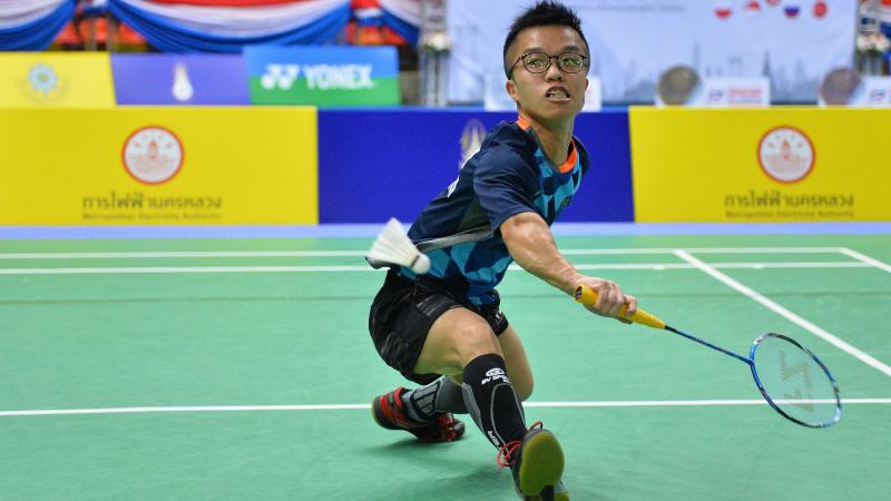 male Para badminton player Wong Chun Yim goes to hit a backhand