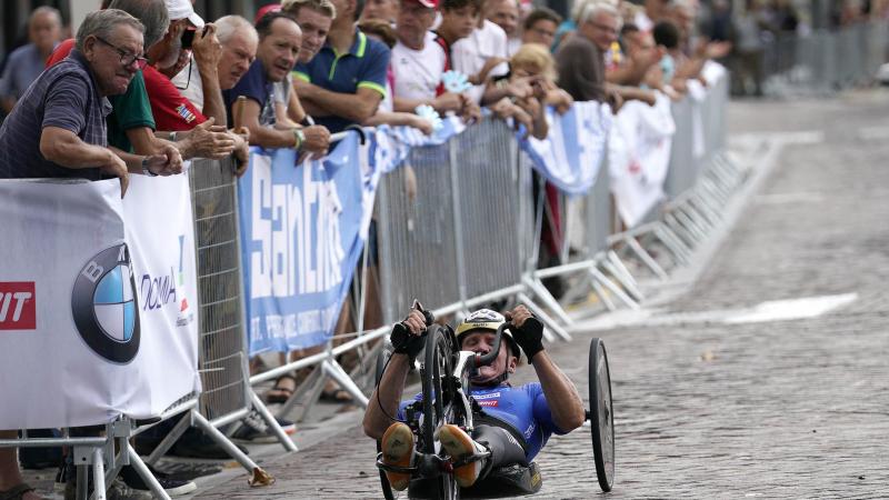 male Para cyclist Fabrizio Cornegliani riding a handbike on a road