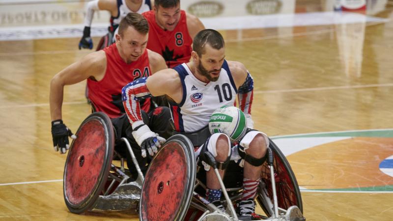 male wheelchair rugby player Josh Wheeler of USA sprints away with the ball