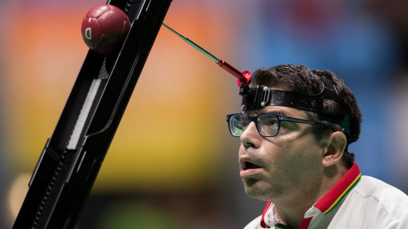 male boccia player Jose Macedo prepares to take a shot