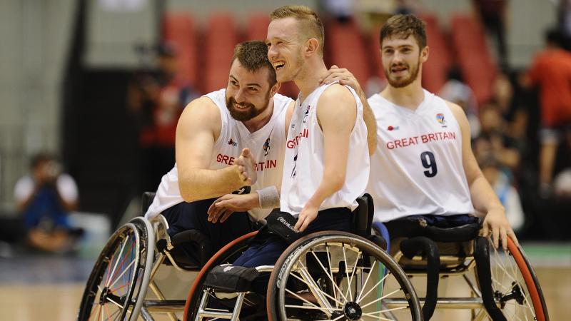 male wheelchair basketball player Gregg Warburton being hugged by a teammate