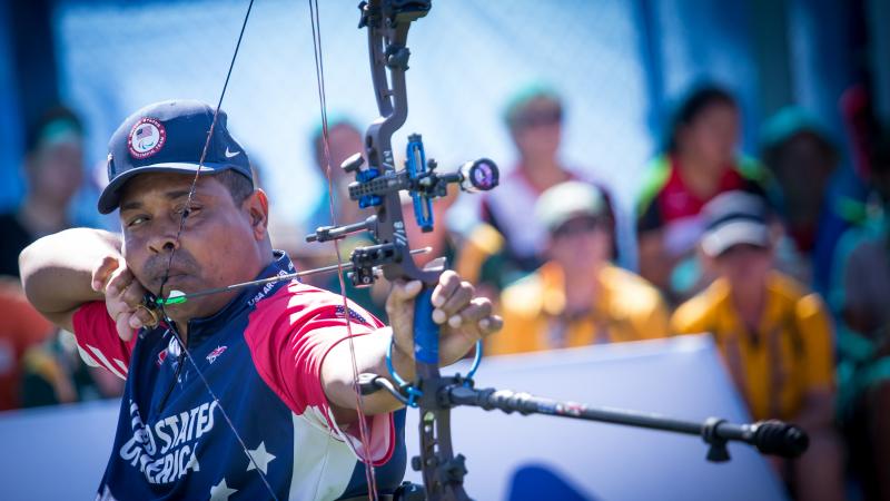 male Para archer Andre Shelby prepares to shoot an arrow