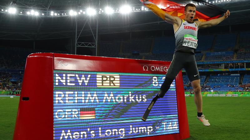 Man jumping and holding the flag of Germany