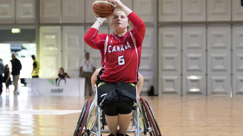 female wheelchair basketballer Arinn Young prepares to take a shot