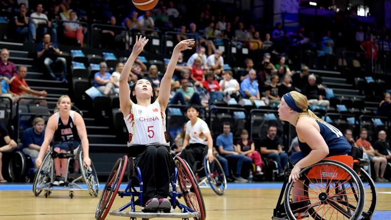 female wheelchair basketballer Xuemei Zhang challenges for the ball