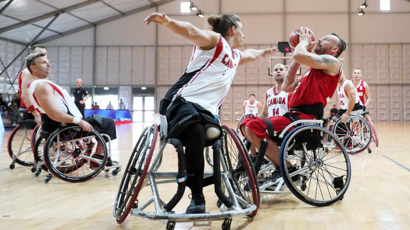 Polish and Canadian male wheelchair basketballers fighting it out on the court