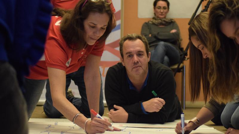 Representatives from Latin American NPCs work on a tarks during a marketing and communications workshop in Bogota