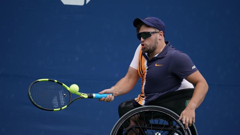 male wheelchair tennis player Dylan Alcott hits a forehand