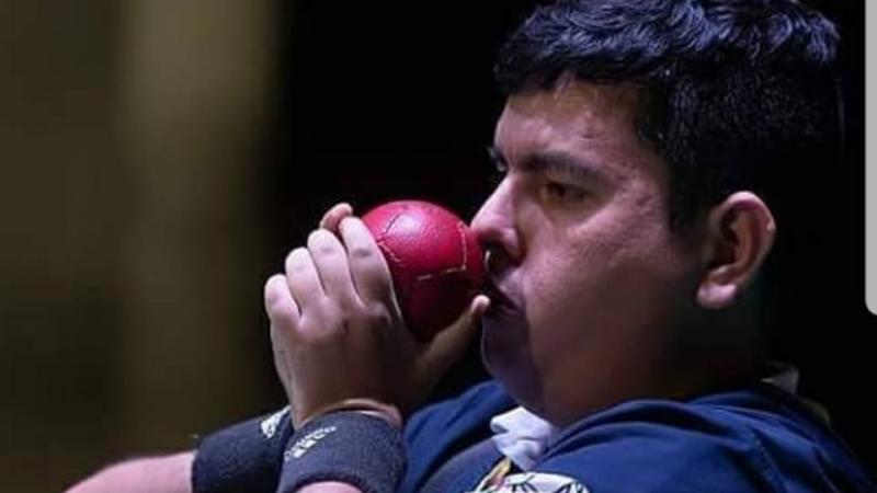 male boccia player Euclides Grisales prepares to throw the ball