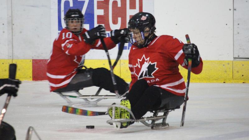 two female Canadian Para ice hockey players on the ice