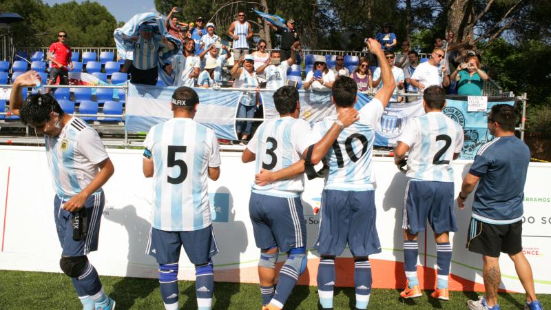 a group of Argentinian blind footballers dancing with their fans