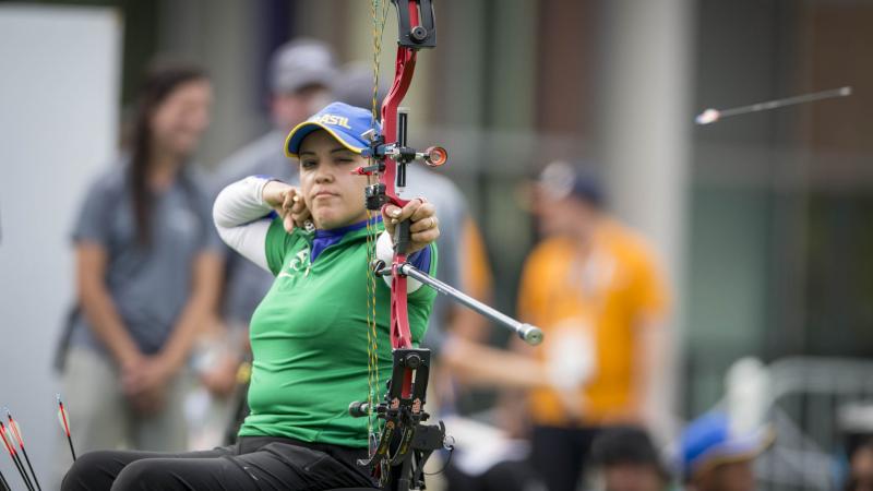female Para archer Jane Gogel pulls back an arrow ready to shoot