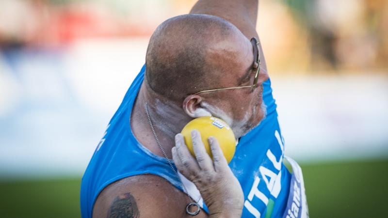 male Para athlete Giuseppe Campoccio prepares to throw a shot put