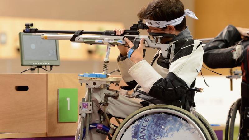 Man in a wheelchair shooting a rifle