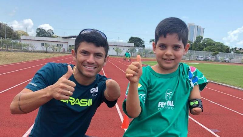 Man and boy with an impairment in the left arm 