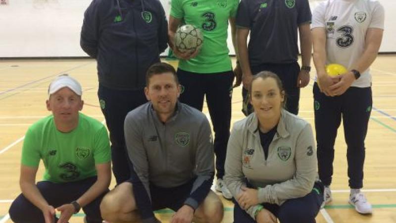 a group of blind footballers in an Ireland gym holding footballs