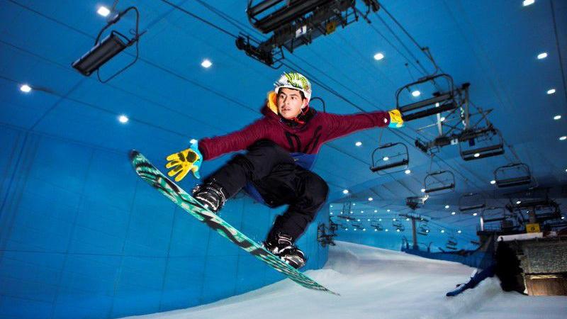 Man snowboarding in an indoor ski area