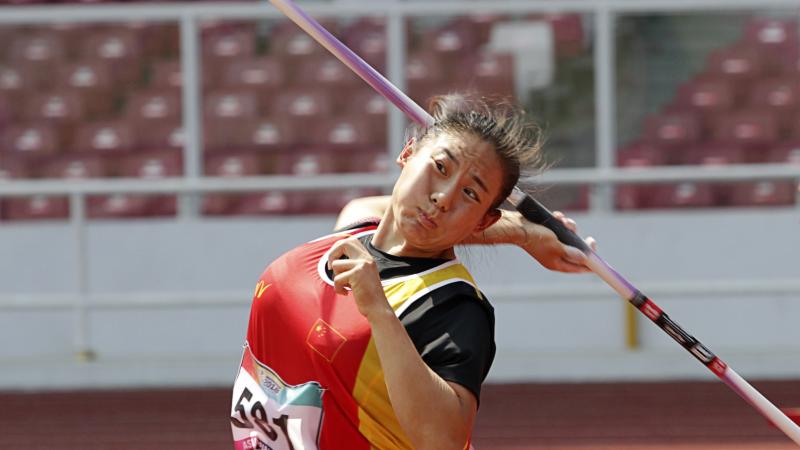 female Para athlete Zhao Yuping throws a javelin