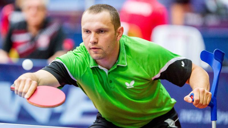 male Para table tennis player Viktor Didukh plays a forehand