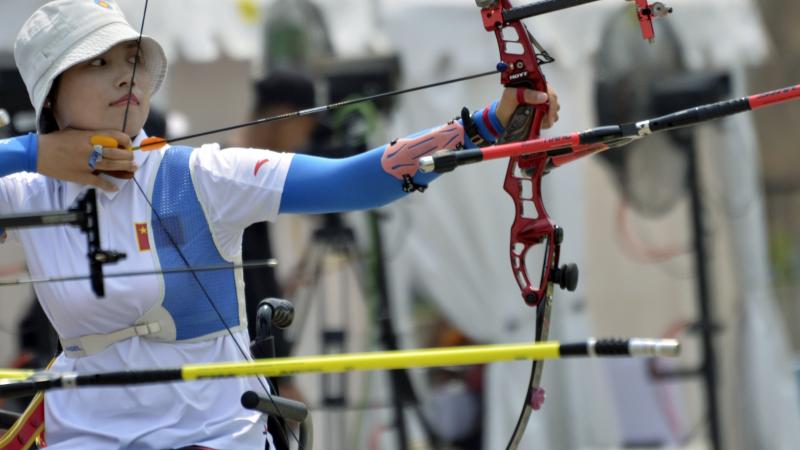female Para archer Wu Chunyan draws back her bow to shoot an arrow
